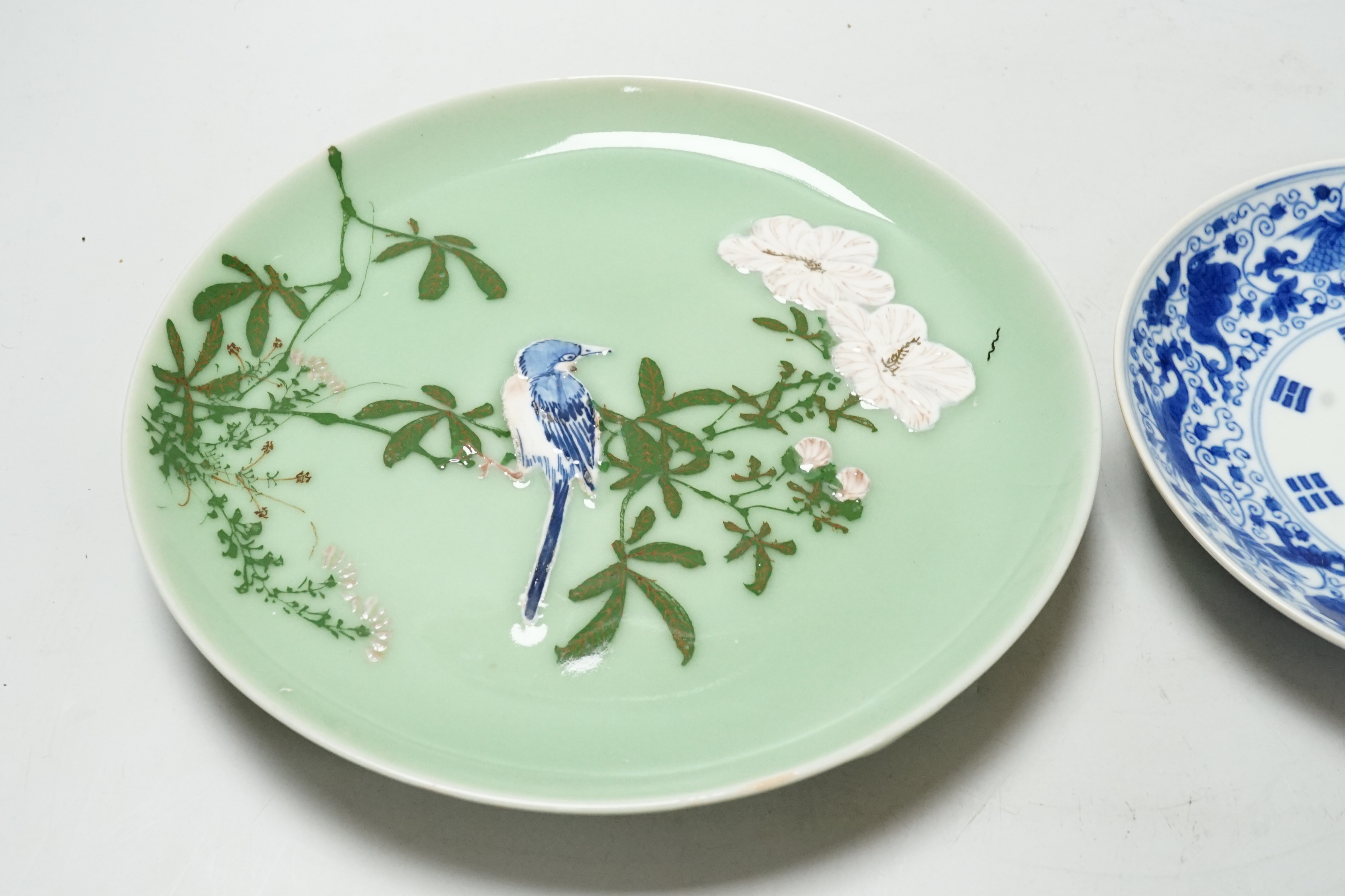 A Japanese celadon ground dish and a Chinese blue and white dish, largest 22cm diameter